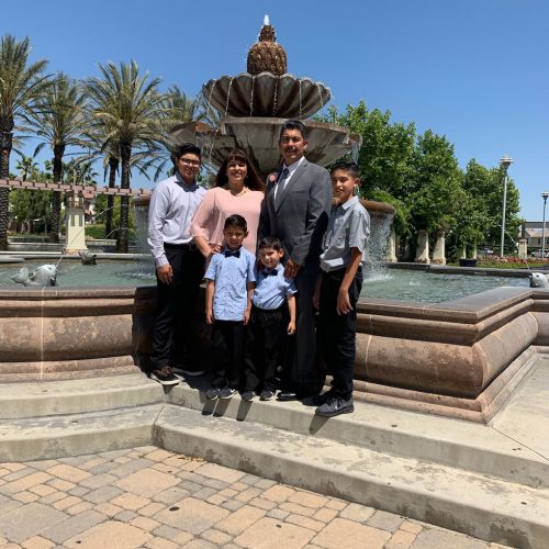 Ramirez Family of Nicomite Termite and Pest Control posing in front of a water fountain